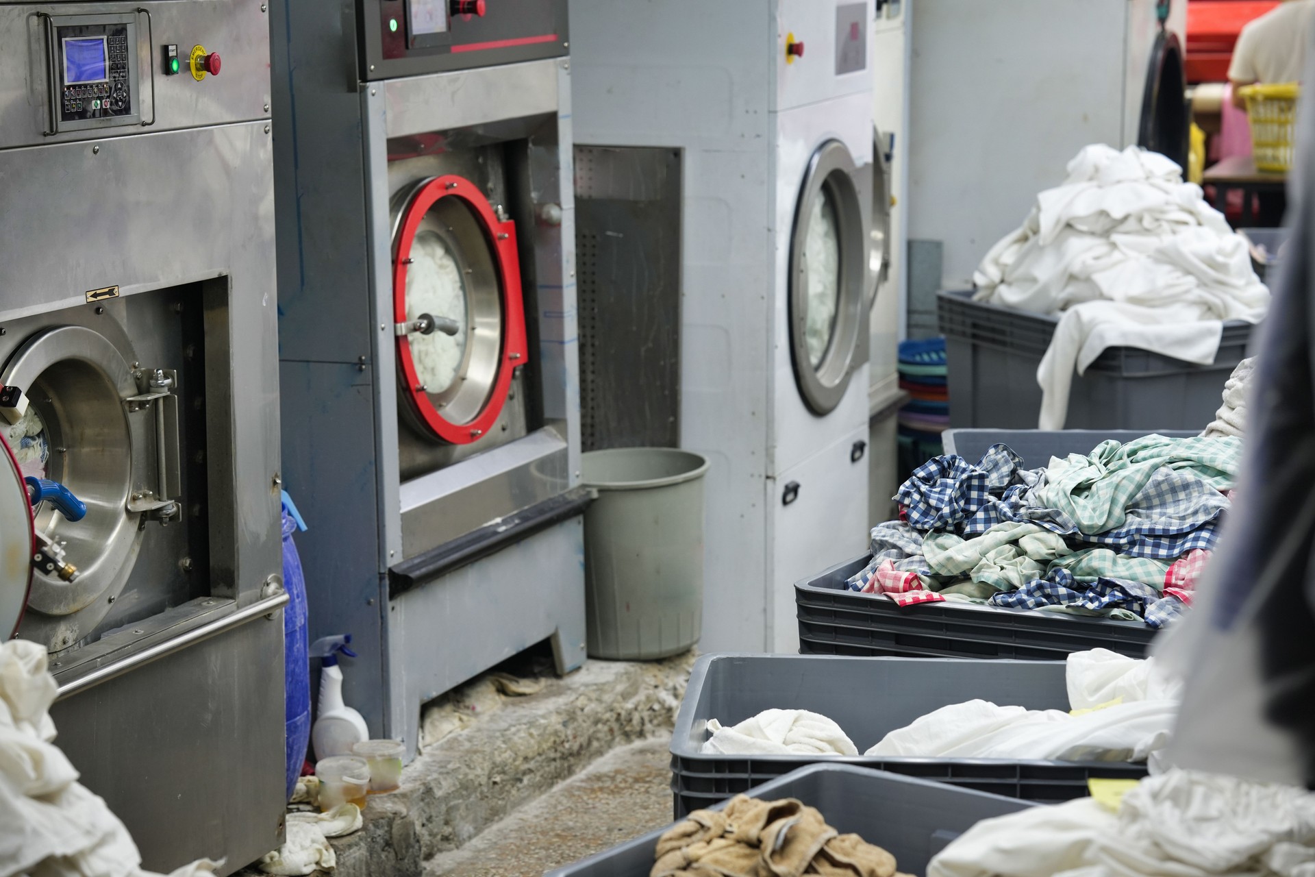 Industrial Laundry Machines with Bins of Clothes