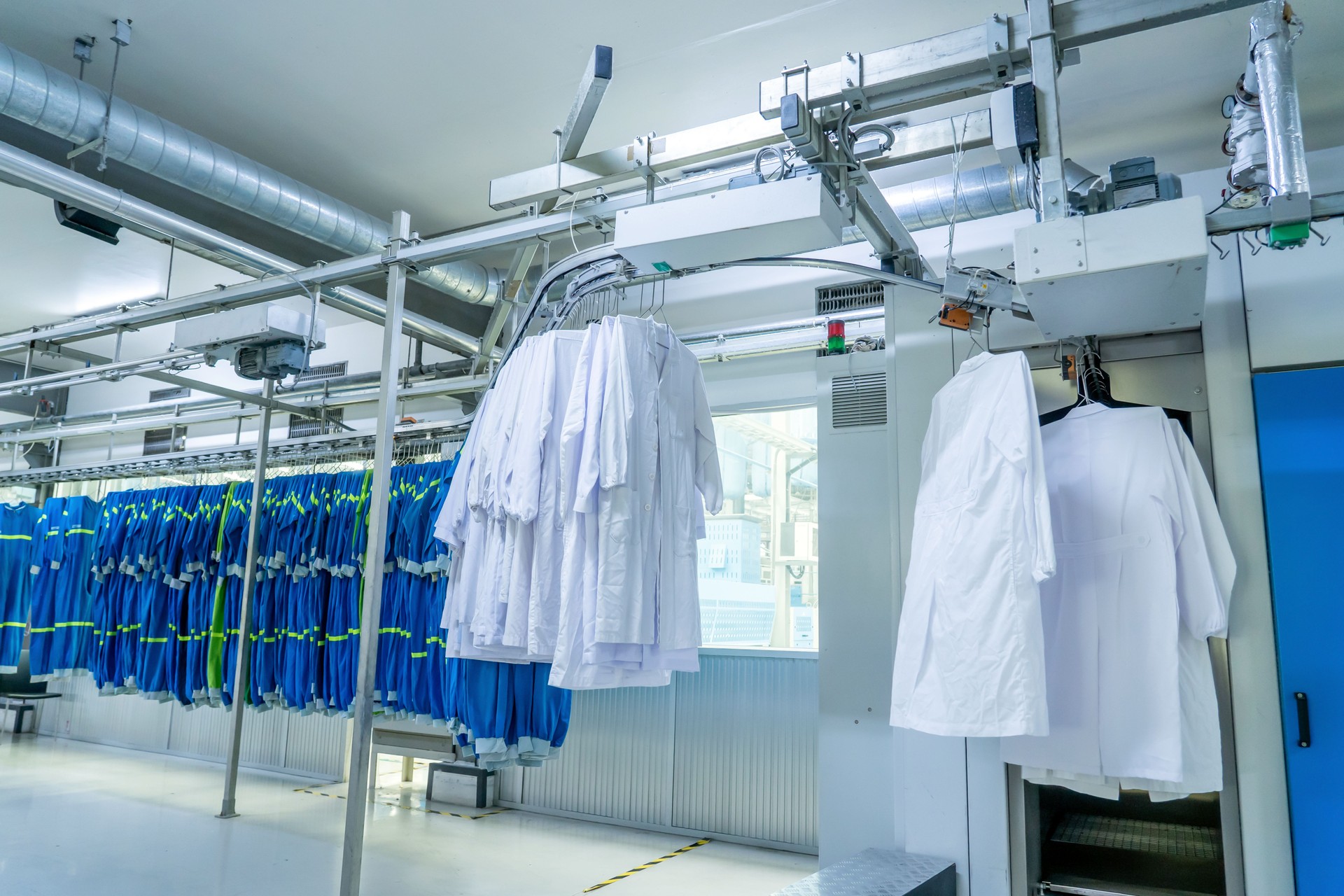Washed clothes are being conveyed to ironing machine